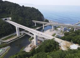<p>　全線開通を控える三陸沿岸道路（手前）＝８月、岩手県野田村（国交省三陸国道事務所提供）</p>