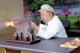 　重要軍需工場を現地指導し、狙撃用ライフルを発射する北朝鮮の金正恩朝鮮労働党総書記（朝鮮中央通信＝共同）