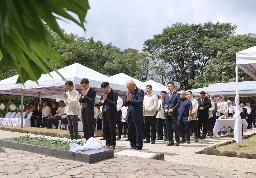 　１５日、フィリピン・ルソン島ラグナ州のカリラヤ日本人戦没者慰霊園で献花し手を合わせる慰霊祭の参加者（共同）