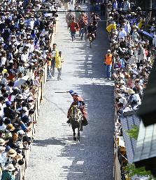　多度大社の「上げ馬神事」で、坂に向かって駆け出す馬＝５月