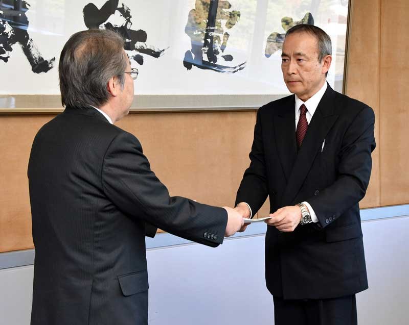 佐藤教育長（左）に調査報告書を手渡す金子委員長＝８日、野田市