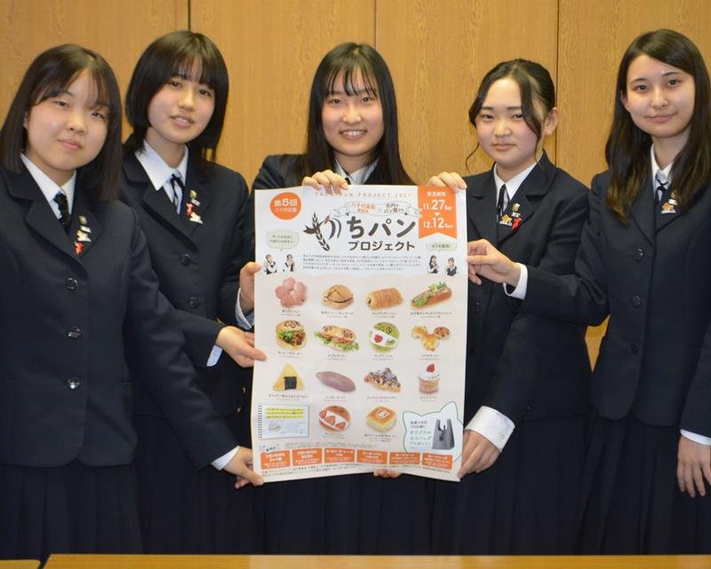 地元店と協力して開発したご当地パンをポスターでＰＲする八千代高の生徒＝八千代市役所
