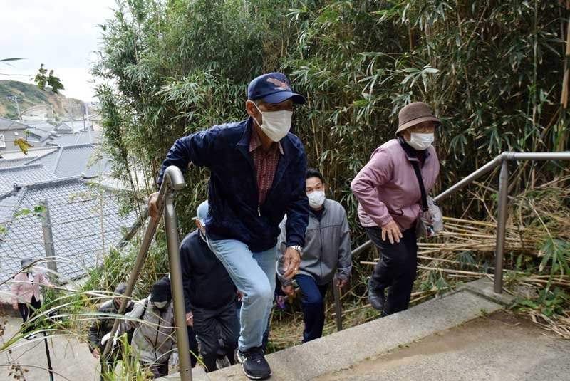 高台に続く避難路を歩いて上がる住民＝銚子市
