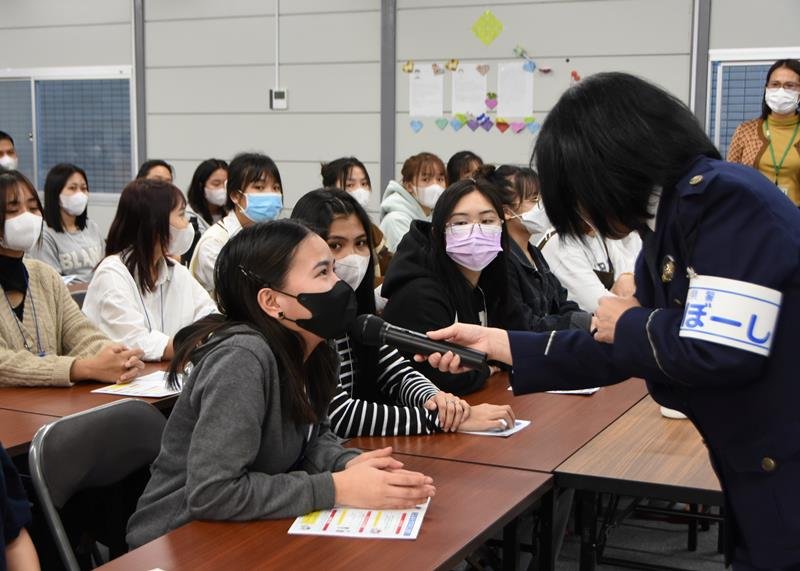 千葉県警の講話で質問に答える技能実習生の女性（左）＝１４日午後、柏市
