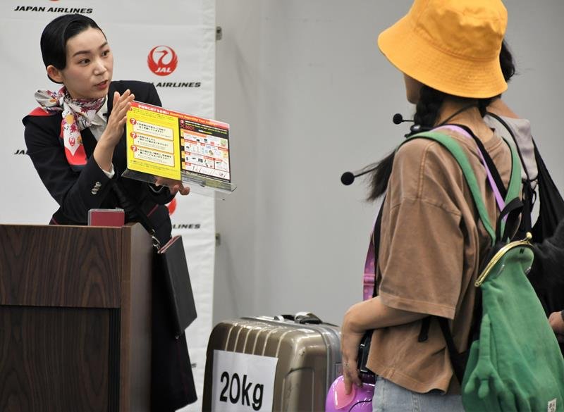旅客サービスのスキルを競うコンテストで接客対応を実演する地上係員（左）＝成田空港
