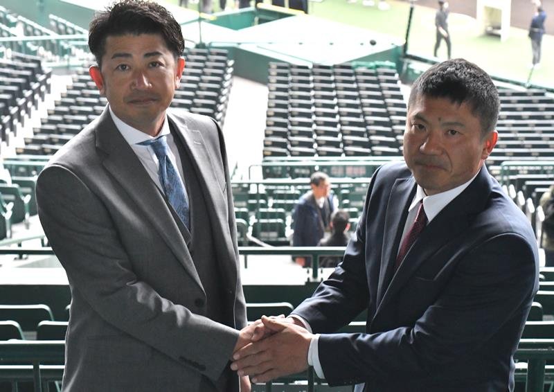 中央学院の相馬幸樹監督（左）と握手する耐久の井原正善監督＝１７日、甲子園
