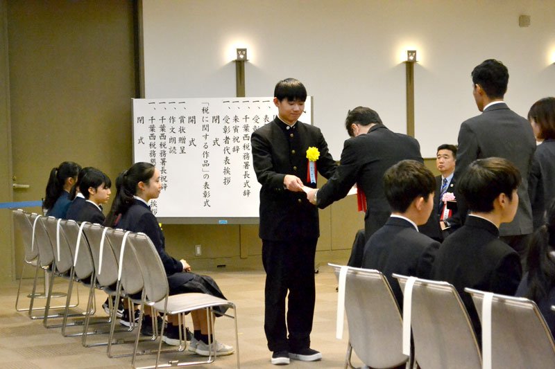 表彰状を受け取る岡田さん＝１１日、千葉市美浜区の幕張メッセ
