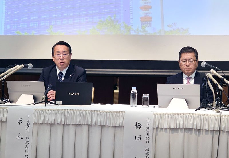 記者会見で経営統合について説明する千葉銀の米本頭取（左）と千葉興銀の梅田頭取＝29日、千葉市中央区