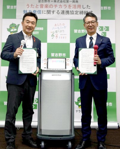 協定書を手にする宮本市長（左）と大坪部長＝習志野市役所