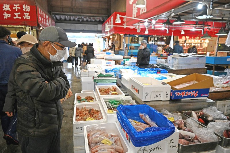 商品を吟味する利用客ら＝２５日、千葉市地方卸売市場