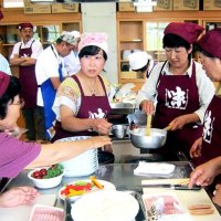 “鴨川の味”料理教室で参加者に調理を支援するメンバー（プロジェクト鴨川味の方舟提供）
