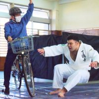 交通事故防止の広報動画撮影で熱演するウルフ選手（右）
