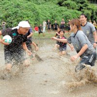 泥水をはね上げながら競り合う選手＝２７日、市原市