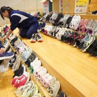 地域の協力で集まった多数の靴を整理する生徒＝勝浦市
